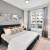 a bedroom with two nightstands and a window