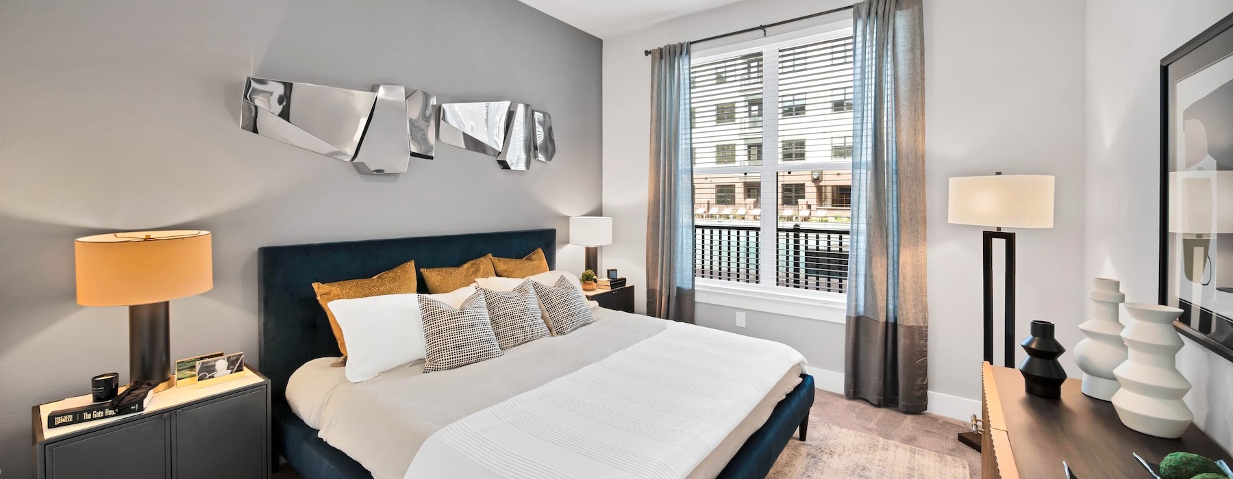 a bedroom with two nightstands and a window