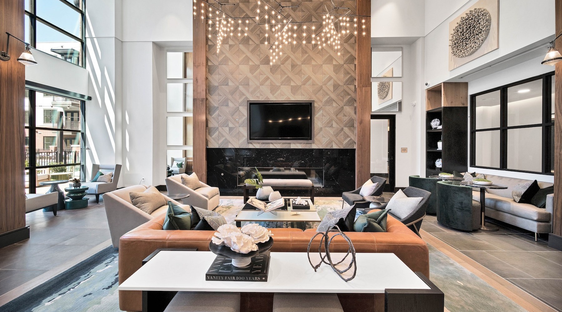 a clubhouse room with a couch, chairs and tables