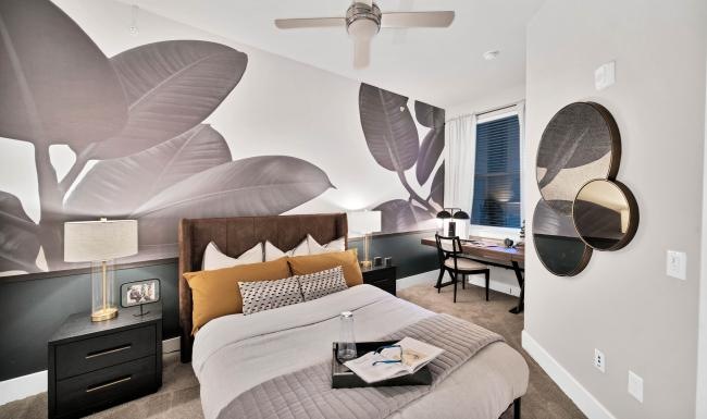 a bedroom with a bed and a fan