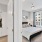 a bedroom with a bed and a large window